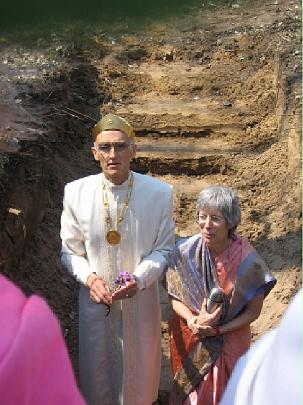 05 flowers-wishes.jpg - Raja Graham and his wife Leanne making wishes at the site of the building's cornerstone.